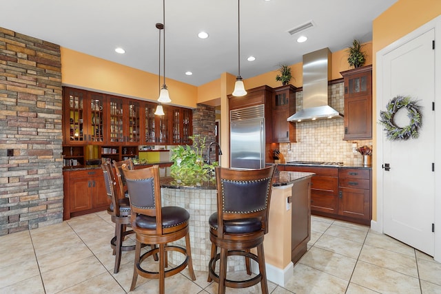2308 Desert View Rd NE, Rio Rancho, NM 87144 - kitchen featuring stainless steel appliances, wall chimney exhaust hood, light tile patterned floors, glass insert cabinets, and recessed lighting