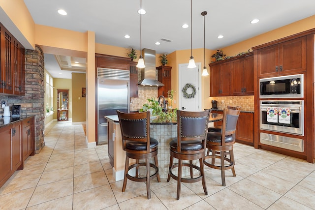 2308 Desert View Rd NE, Rio Rancho, NM 87144 - kitchen with built in appliances, wall chimney range hood, a warming drawer, decorative backsplash, and recessed lighting
