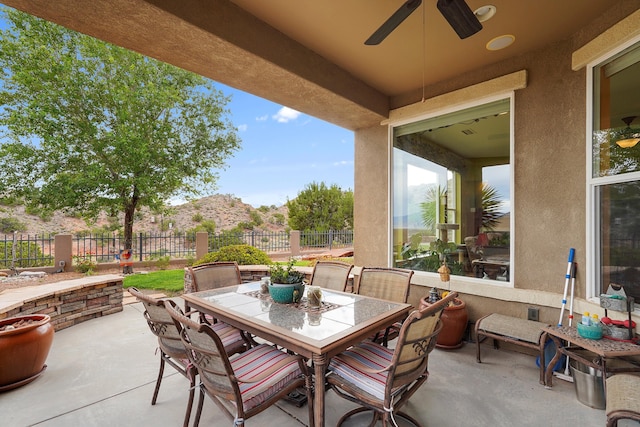 2308 Desert View Rd NE, Rio Rancho, NM 87144 - view of patio featuring a ceiling fan, outdoor dining area, and a mountain view