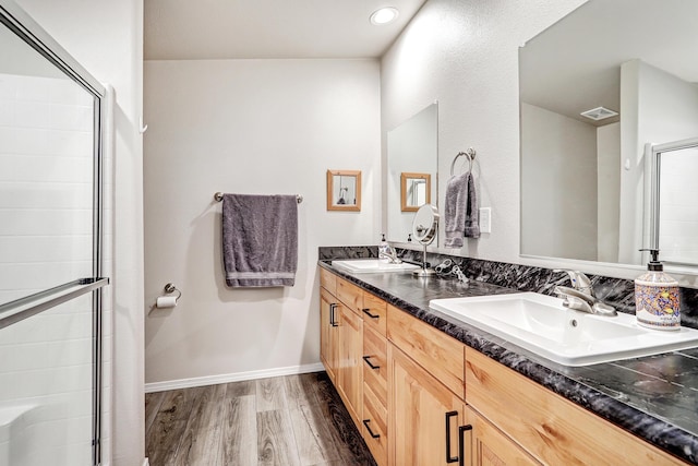 150 Ponderosa Way, Jemez Springs, NM 87025 - bathroom featuring double vanity, wood finished floors, a shower with shower door, and recessed lighting