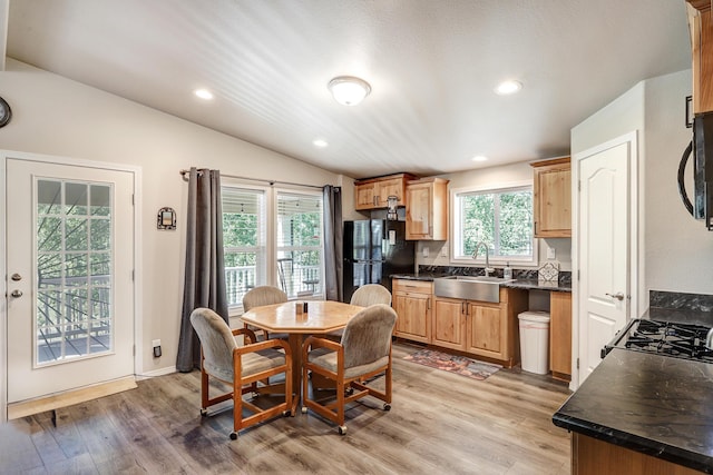 150 Ponderosa Way, Jemez Springs, NM 87025 - kitchen featuring black appliances, dark countertops, lofted ceiling, light wood finished floors, and recessed lighting