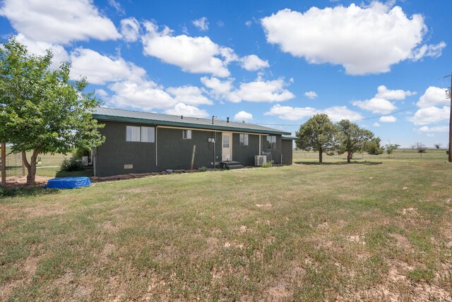1257 Dinkle Rd, Stanley, NM 87056 - back of house featuring a yard, a metal roof, and entry steps