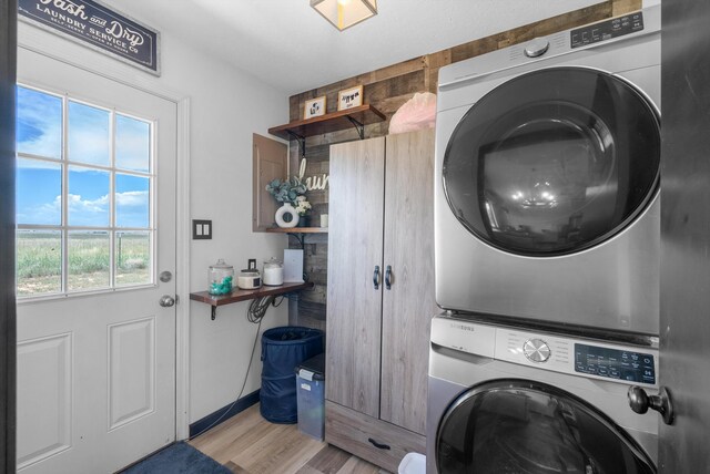 1257 Dinkle Rd, Stanley, NM 87056 - laundry room featuring stacked washer and clothes dryer and light wood-style floors