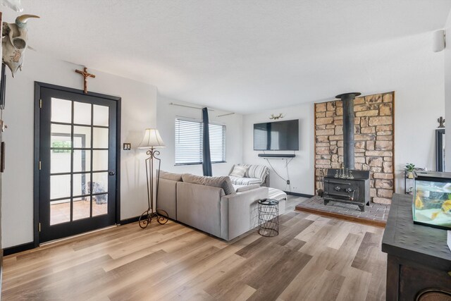 1257 Dinkle Rd, Stanley, NM 87056 - living room featuring plenty of natural light, light wood-type flooring, and a wood stove