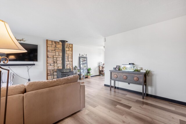 1257 Dinkle Rd, Stanley, NM 87056 - living area featuring a wood stove and light wood-style floors