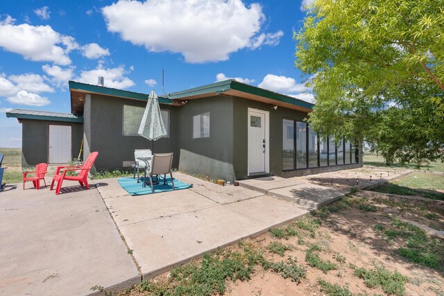 1257 Dinkle Rd, Stanley, NM 87056 - back of house featuring stucco siding, a patio, and a metal roof
