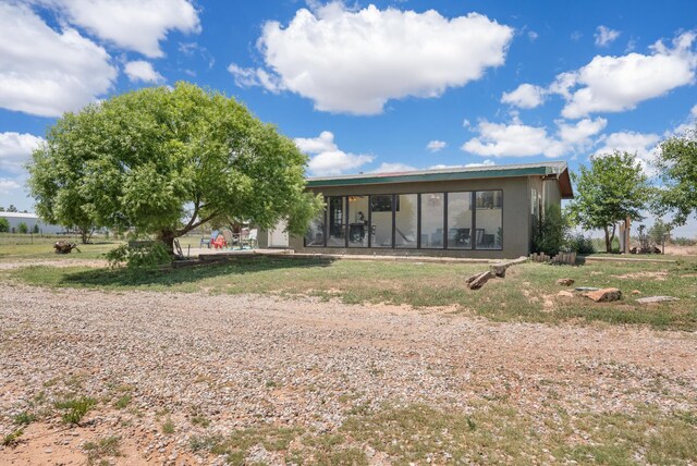 1257 Dinkle Rd, Stanley, NM 87056 - back of house with stucco siding and a sunroom