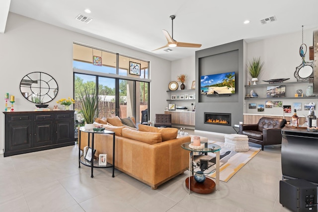 3204 Maxum Ln NW, Albuquerque, NM 87104 - living area with ceiling fan, a glass covered fireplace, light tile patterned flooring, and recessed lighting
