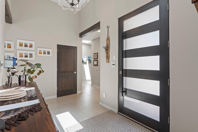 3204 Maxum Ln NW, Albuquerque, NM 87104 - entryway with light tile patterned floors, a high ceiling, and a chandelier