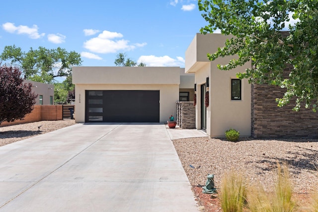 3204 Maxum Ln NW, Albuquerque, NM 87104 - contemporary home with driveway, stucco siding, and an attached garage