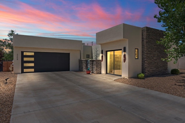 3204 Maxum Ln NW, Albuquerque, NM 87104 - contemporary home with stucco siding, a garage, and stone siding