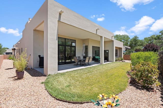 3204 Maxum Ln NW, Albuquerque, NM 87104 - back of property with stucco siding and a patio
