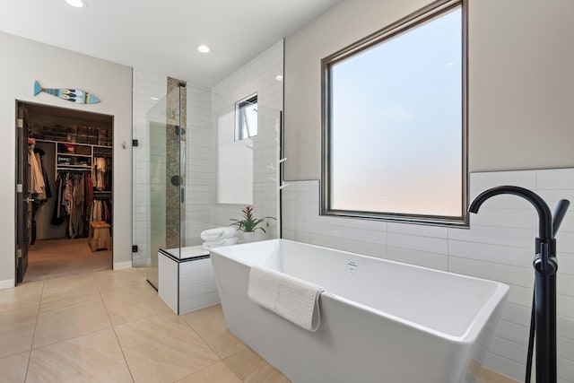 3204 Maxum Ln NW, Albuquerque, NM 87104 - bathroom with a shower stall, a walk in closet, a freestanding tub, tile patterned flooring, and recessed lighting