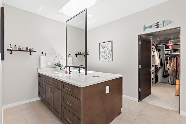 3204 Maxum Ln NW, Albuquerque, NM 87104 - bathroom featuring vanity, tile patterned floors, and a spacious closet