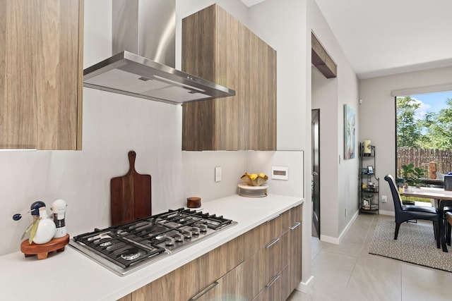 3204 Maxum Ln NW, Albuquerque, NM 87104 - kitchen with wall chimney exhaust hood, modern cabinets, stainless steel gas cooktop, and light countertops