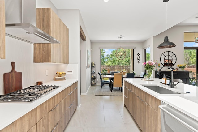 3204 Maxum Ln NW, Albuquerque, NM 87104 - kitchen featuring wall chimney range hood, modern cabinets, appliances with stainless steel finishes, and light countertops