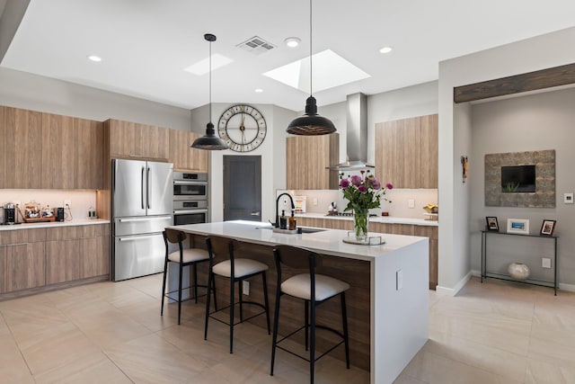 3204 Maxum Ln NW, Albuquerque, NM 87104 - kitchen featuring stainless steel appliances, wall chimney exhaust hood, modern cabinets, a breakfast bar area, and recessed lighting