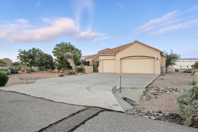736 Gray Hawk Dr NE, Rio Rancho, NM 87144 - view of front of property with an attached garage, concrete driveway, stucco siding, and a tiled roof