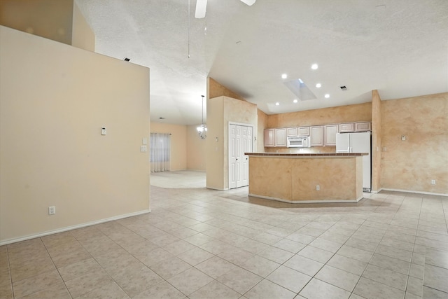 736 Gray Hawk Dr NE, Rio Rancho, NM 87144 - kitchen with white appliances, light tile patterned flooring, lofted ceiling, ceiling fan, and open floor plan