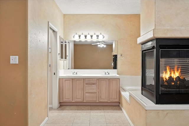 736 Gray Hawk Dr NE, Rio Rancho, NM 87144 - bathroom with a multi sided fireplace, tile patterned flooring, double vanity, a bath, and a ceiling fan