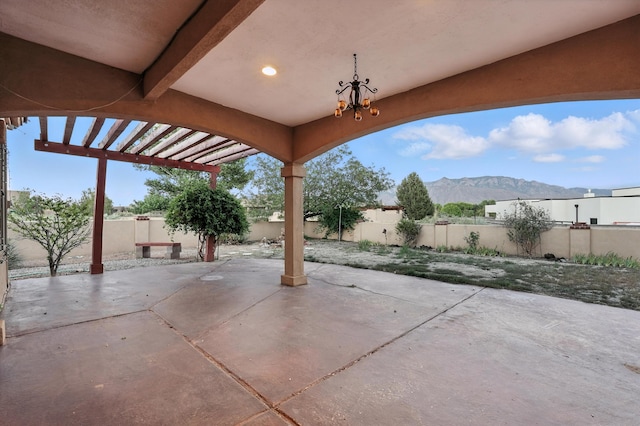 736 Gray Hawk Dr NE, Rio Rancho, NM 87144 - fenced backyard with a mountain view, a pergola, and a patio area