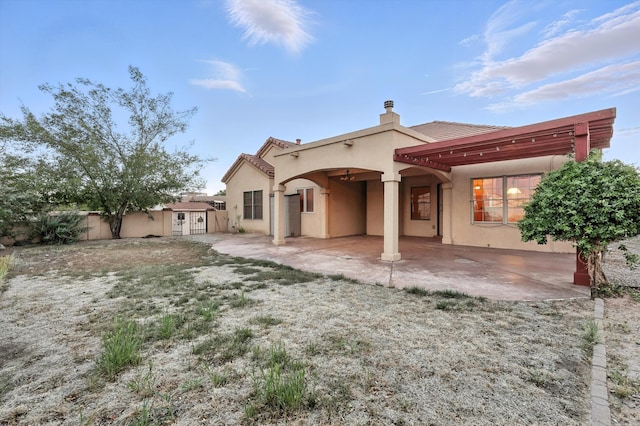 736 Gray Hawk Dr NE, Rio Rancho, NM 87144 - back of property with a patio, a chimney, stucco siding, a tiled roof, and a pergola