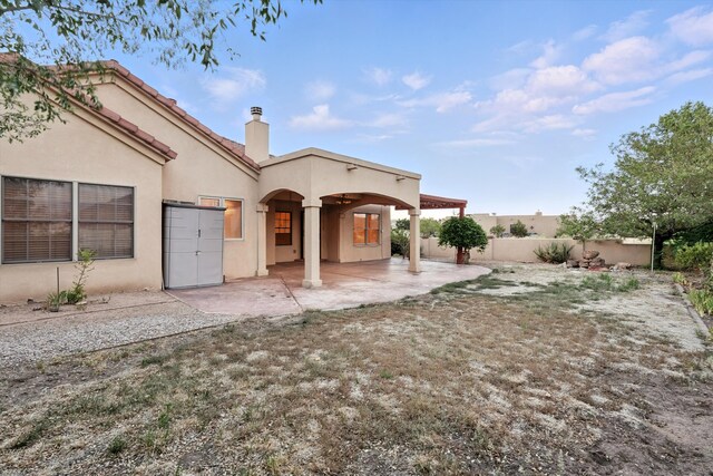 736 Gray Hawk Dr NE, Rio Rancho, NM 87144 - rear view of property featuring a patio area, stucco siding, a chimney, and a fenced backyard