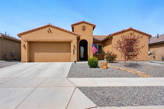 4529 Skyline Loop NE, Rio Rancho, NM 87144 - mediterranean / spanish-style house with driveway, stucco siding, a garage, and a tile roof