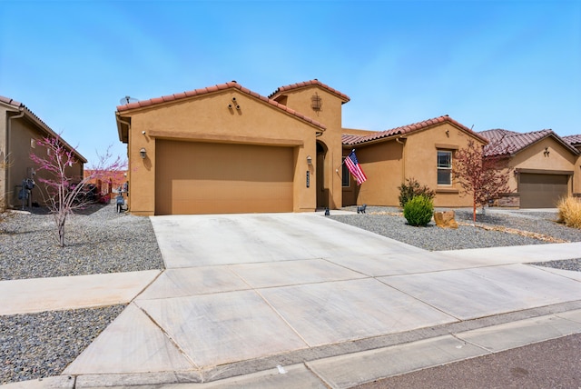 4529 Skyline Loop NE, Rio Rancho, NM 87144 - mediterranean / spanish-style home featuring stucco siding, concrete driveway, a garage, and a tile roof