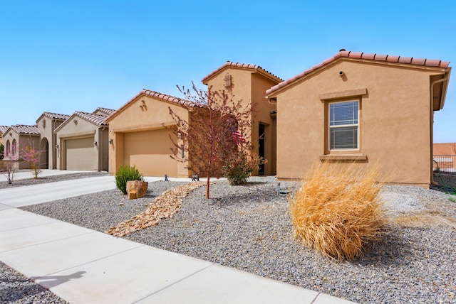 4529 Skyline Loop NE, Rio Rancho, NM 87144 - mediterranean / spanish house with a garage, stucco siding, driveway, and a tiled roof