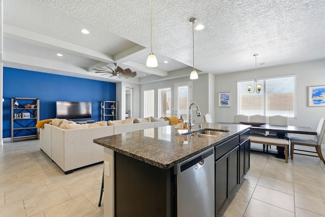 4529 Skyline Loop NE, Rio Rancho, NM 87144 - kitchen featuring stainless steel dishwasher, dark stone countertops, an island with sink, pendant lighting, and a textured ceiling