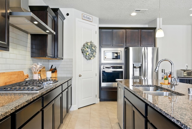 4529 Skyline Loop NE, Rio Rancho, NM 87144 - kitchen featuring appliances with stainless steel finishes, wall chimney range hood, dark stone counters, hanging light fixtures, and tasteful backsplash
