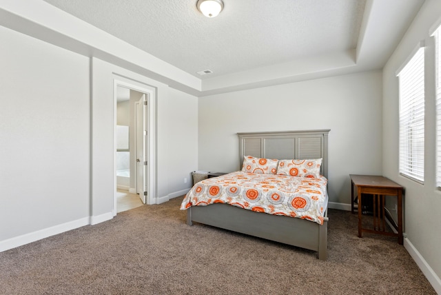 4529 Skyline Loop NE, Rio Rancho, NM 87144 - carpeted bedroom with a tray ceiling, ensuite bath, and a textured ceiling