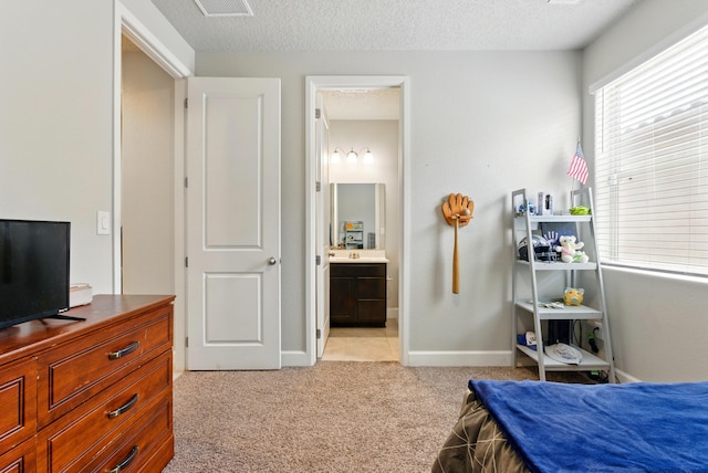 4529 Skyline Loop NE, Rio Rancho, NM 87144 - bedroom featuring light carpet, a textured ceiling, and ensuite bathroom