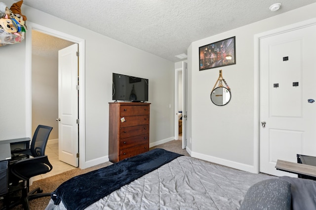4529 Skyline Loop NE, Rio Rancho, NM 87144 - bedroom with a desk, a textured ceiling, and carpet flooring
