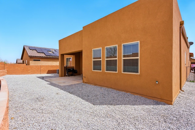 4529 Skyline Loop NE, Rio Rancho, NM 87144 - rear view of property featuring a fenced backyard, a patio, and stucco siding