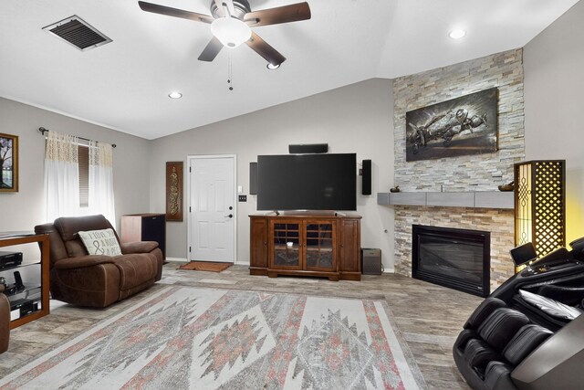 9616 Eucariz Ave SW, Albuquerque, NM 87121 - living area with a stone fireplace, ceiling fan, lofted ceiling, wood finished floors, and recessed lighting