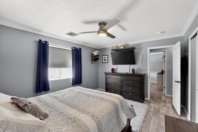 9616 Eucariz Ave SW, Albuquerque, NM 87121 - bedroom with light wood-style floors, ornamental molding, a textured ceiling, and a ceiling fan