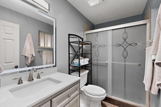 9616 Eucariz Ave SW, Albuquerque, NM 87121 - bathroom with vanity, a shower stall, wood finished floors, and a textured ceiling