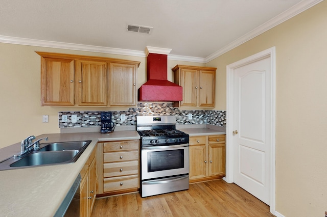 701 Autumn Meadows Dr, Rio Rancho, NM 87144 - kitchen featuring stainless steel range with gas stovetop, custom exhaust hood, ornamental molding, light wood-type flooring, and backsplash