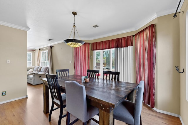 701 Autumn Meadows Dr, Rio Rancho, NM 87144 - dining space with crown molding and light wood-style floors
