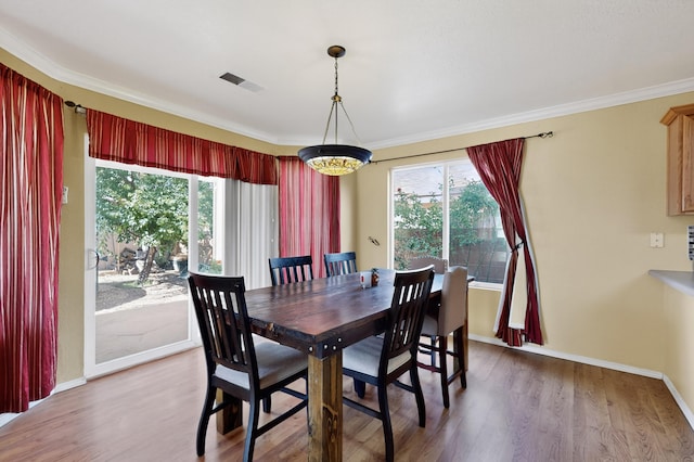 701 Autumn Meadows Dr, Rio Rancho, NM 87144 - dining space featuring plenty of natural light, wood finished floors, and crown molding