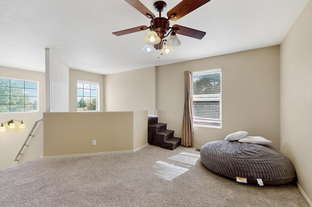 701 Autumn Meadows Dr, Rio Rancho, NM 87144 - sitting room with carpet flooring, a ceiling fan, and an upstairs landing