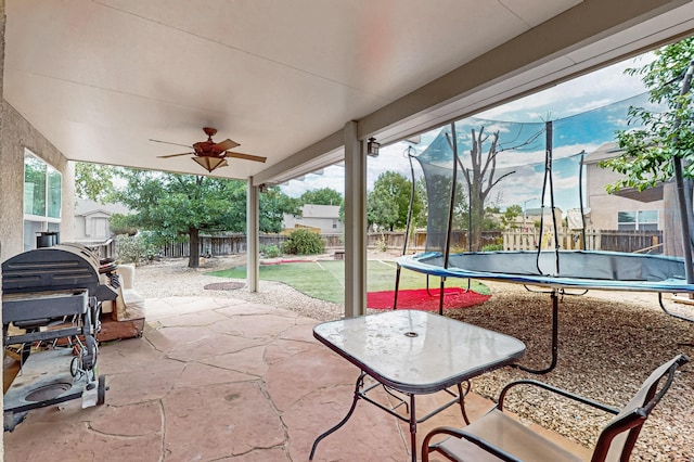 701 Autumn Meadows Dr, Rio Rancho, NM 87144 - fenced backyard with a patio, ceiling fan, and a trampoline