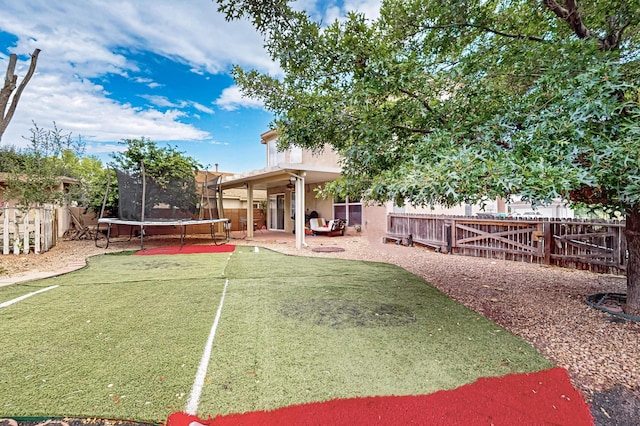 701 Autumn Meadows Dr, Rio Rancho, NM 87144 - fenced backyard with a trampoline and a patio