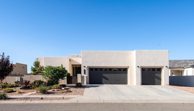1978 Castle Peak Loop NE, Rio Rancho, NM 87144 - pueblo revival-style home featuring an attached garage, concrete driveway, and stucco siding