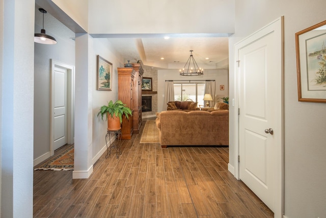1978 Castle Peak Loop NE, Rio Rancho, NM 87144 - living room with wood finished floors, a large fireplace, and a chandelier