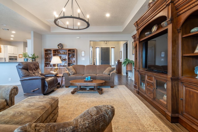 1978 Castle Peak Loop NE, Rio Rancho, NM 87144 - living room featuring a raised ceiling, a chandelier, wood finished floors, and recessed lighting