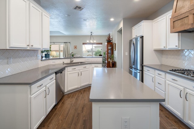 1978 Castle Peak Loop NE, Rio Rancho, NM 87144 - kitchen with stainless steel appliances, range hood, white cabinetry, dark wood-style floors, and recessed lighting