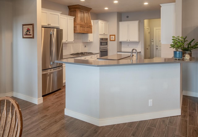 1978 Castle Peak Loop NE, Rio Rancho, NM 87144 - kitchen featuring stainless steel appliances, recessed lighting, dark wood finished floors, tasteful backsplash, and white cabinetry